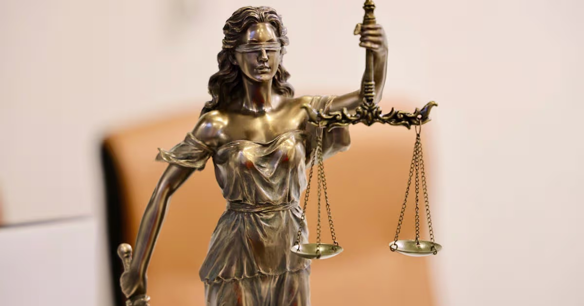 A statue of Lady Justice holding scales, representing protection orders under Australian law.